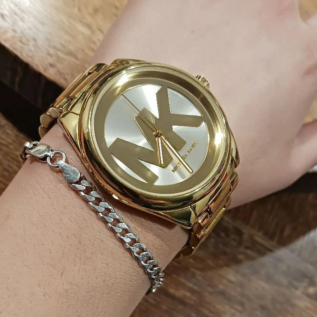 Michael Kors Janelle gold watch worn on wrist with matching gold bracelet