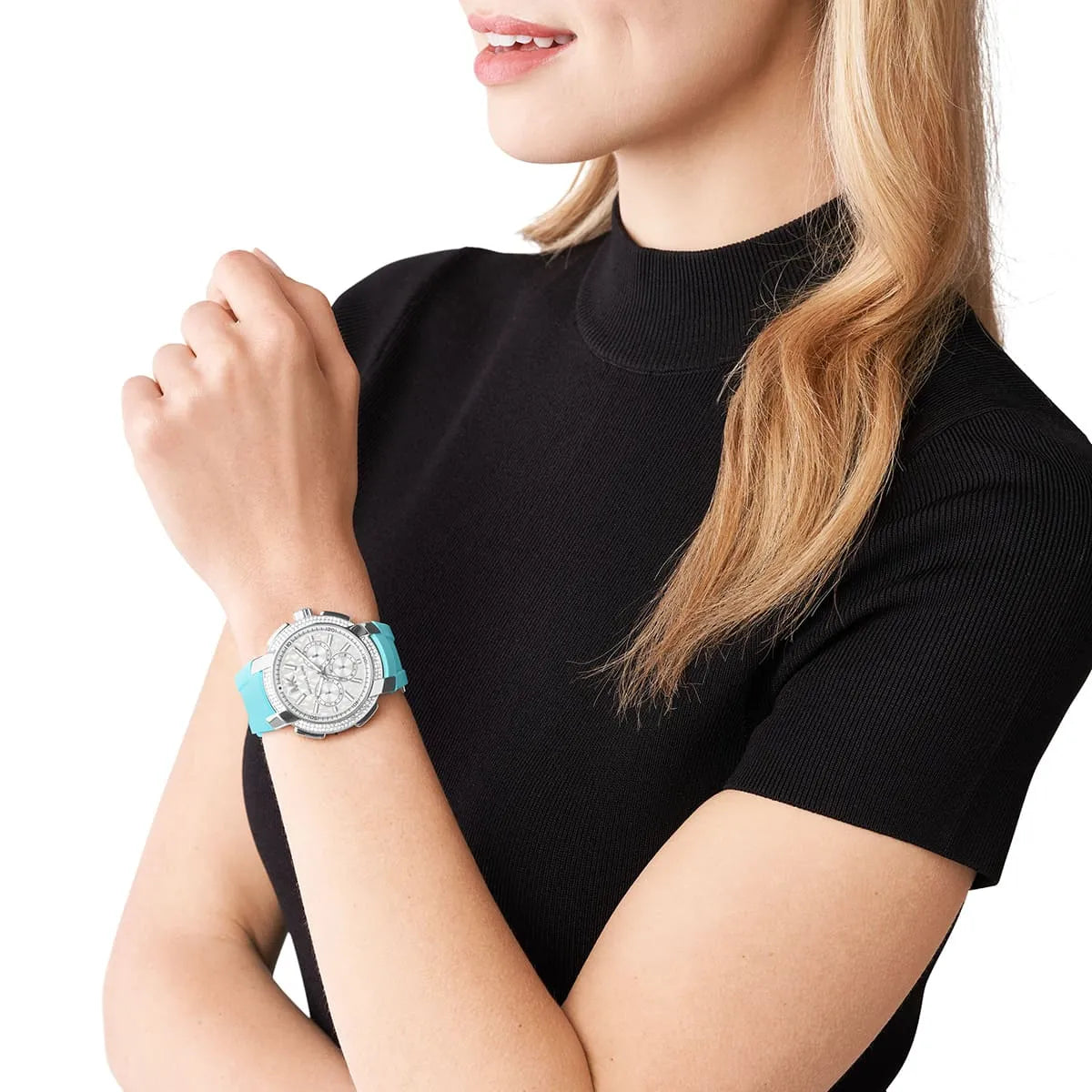 Michael Kors Sidney watch worn on wrist showing silver tone case with turquoise silicone strap