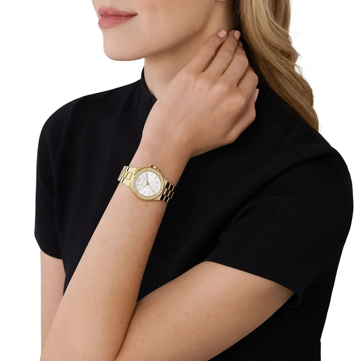 Michael Kors Mini Lennox gold watch worn on wrist with pearlescent dial and crystal bezel