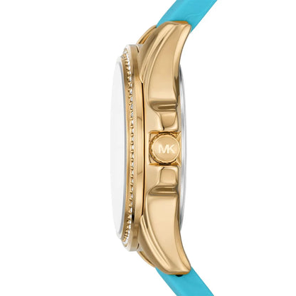 Michael Kors Mini Pilot side view showing gold-tone case profile, crystal bezel detail, and turquoise silicone strap