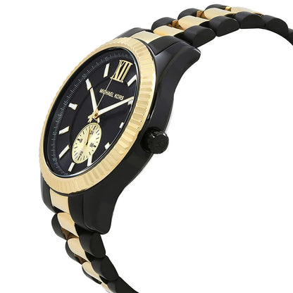 Side angle view of Michael Kors Lexington two-tone watch with gold bezel and black strap