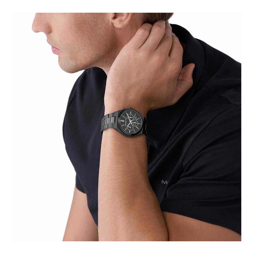 Michael Kors Lennox black chronograph watch worn on male wrist