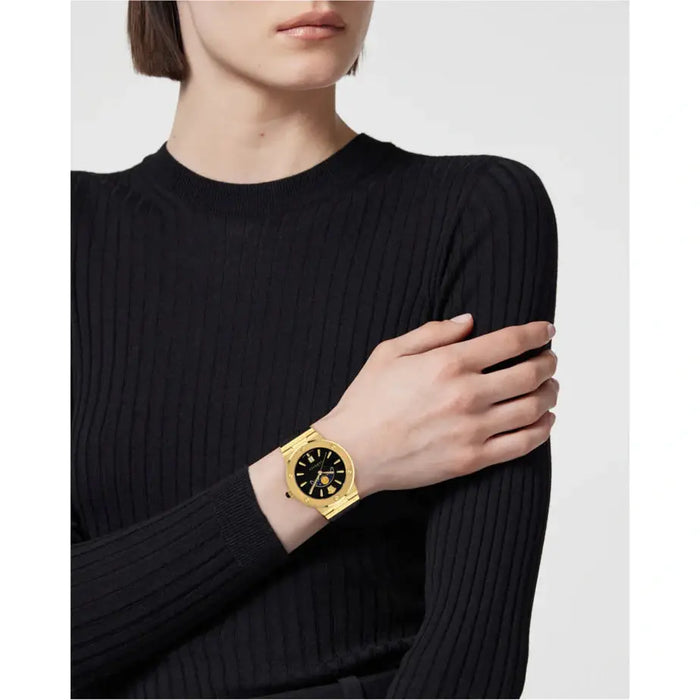 Gold and black Versace Greca watch worn on wrist