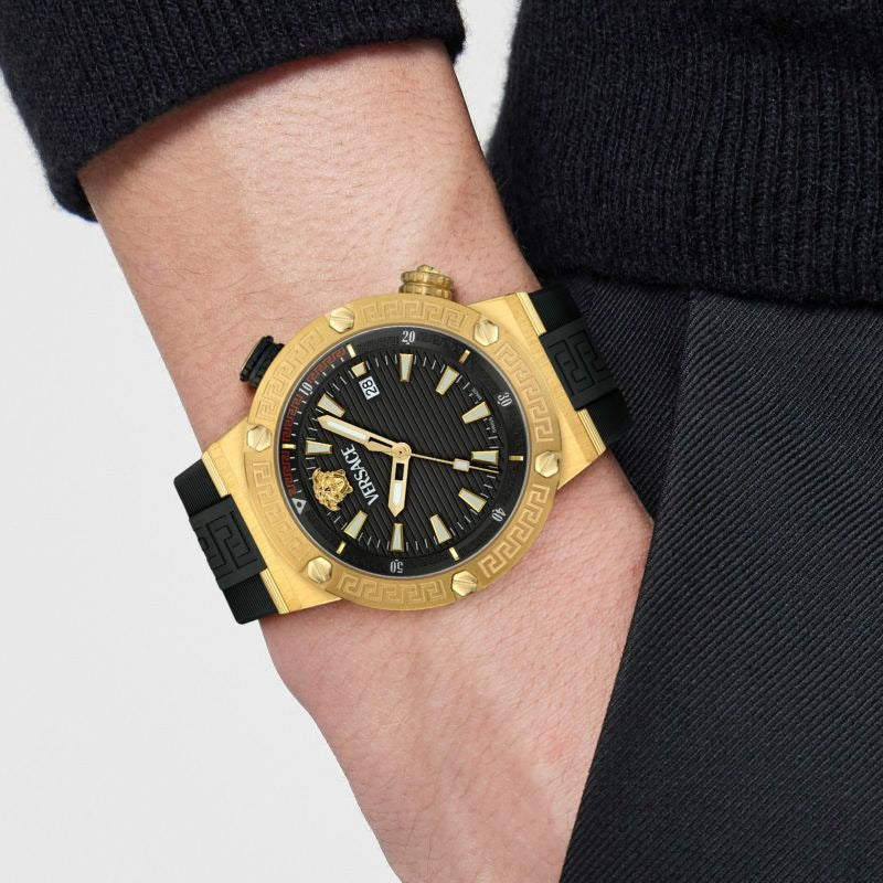 Versace Greca Logo Diver gold watch on wrist with black rubber strap