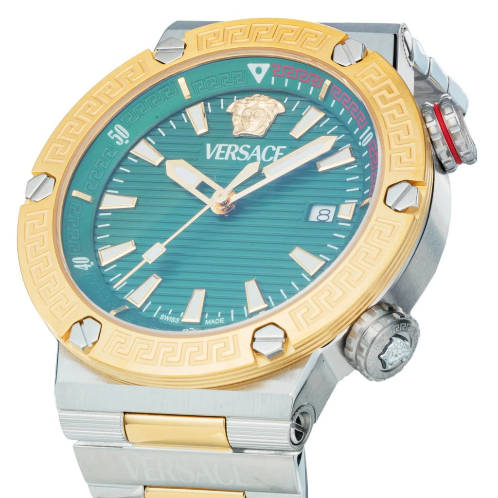 Dial detail of Versace Greca Logo Diver with green sunburst face, Versace logo, and applied indices