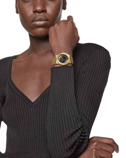 Versace Greca gold watch worn on wrist, black dial and Medusa bezel detail