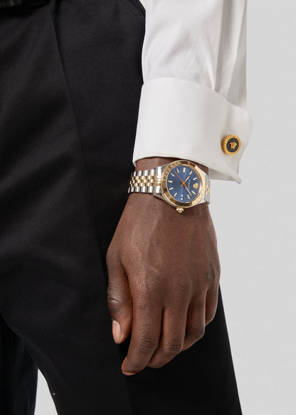 Versace Hellenyium men's watch worn on wrist with blue dial and mixed metal bracelet