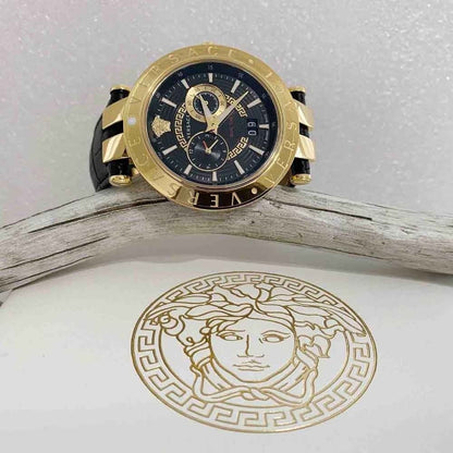 Versace V-Race watch on angled stand showing gold case, black dial, and Medusa logo detail