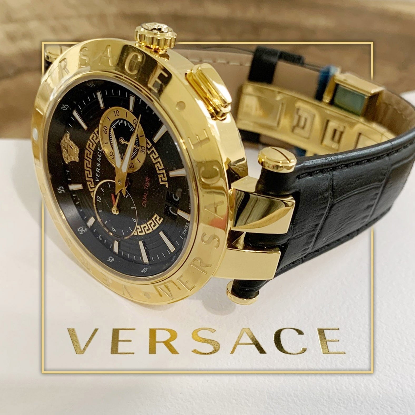 Versace V-Race men's watch worn on wrist with black leather strap and gold-tone chronograph case